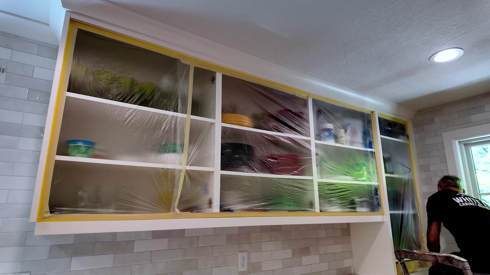 Cabinet openings carefully masked before surface preparation — White Fox Cabinets