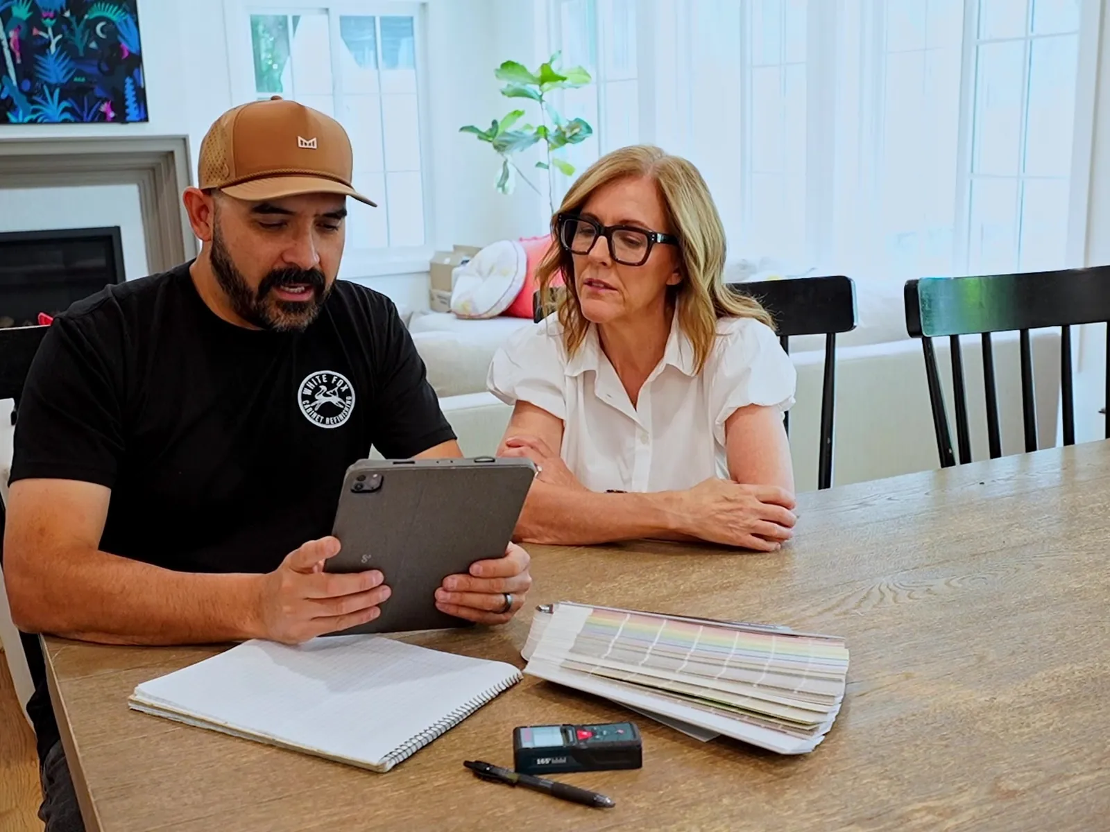 Gabe discussing a cabinet project with a homeowner — White Fox Cabinets
