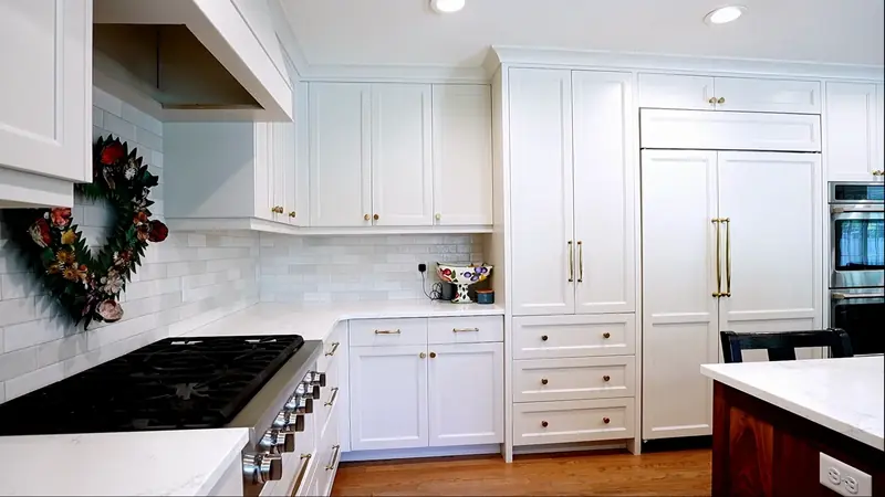 Finished white kitchen cabinets shown in the White Fox refinishing video