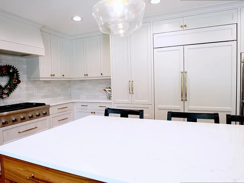 Wide finished white kitchen with a contrasting island
