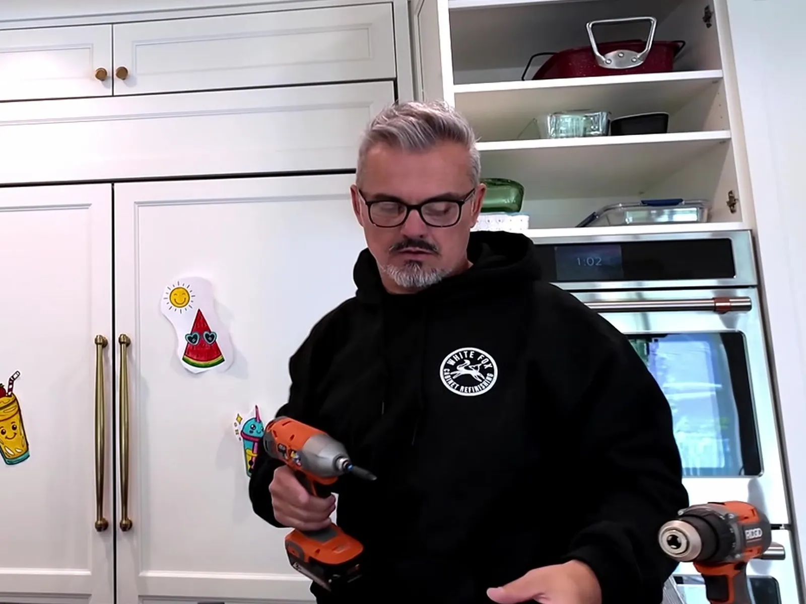 White Fox crew member working on cabinetry with a drill — White Fox Cabinets